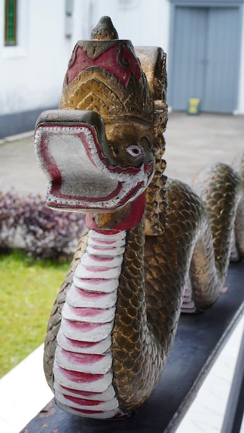 A dragon statue with a red beak and a white and black beak.