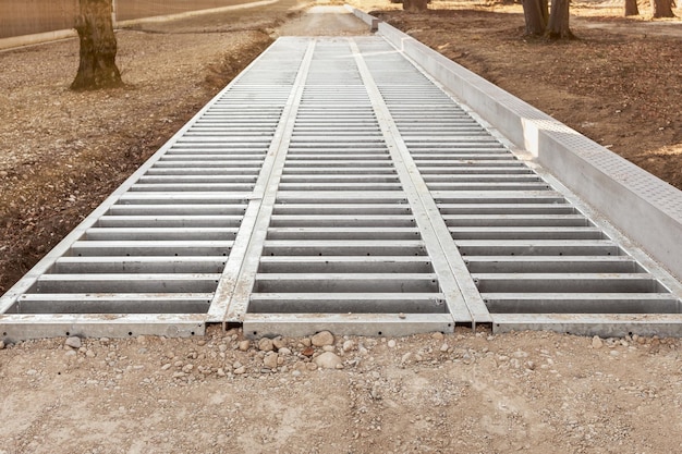 Drainage system on Road Waterway under Road Grate of water drain under Road in Public park