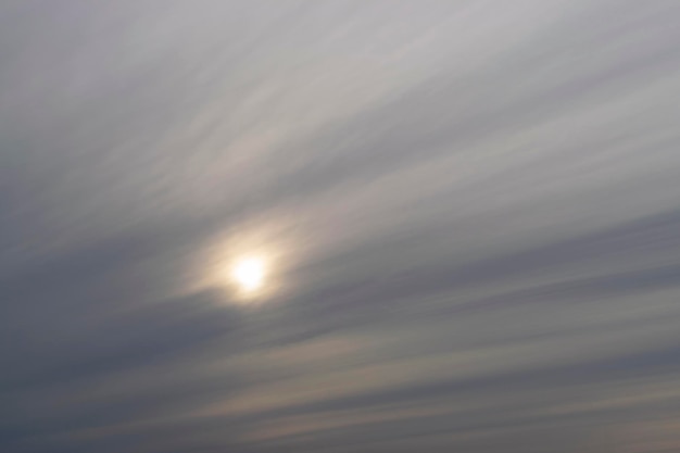 Dramatic blue sky and warm light clouds at sunrise time