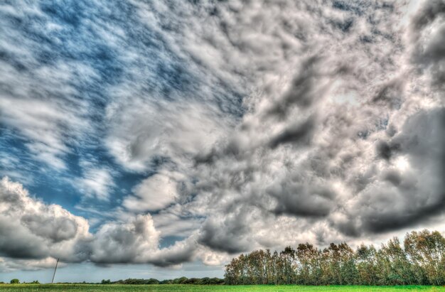 Dramatic clouds over a green field