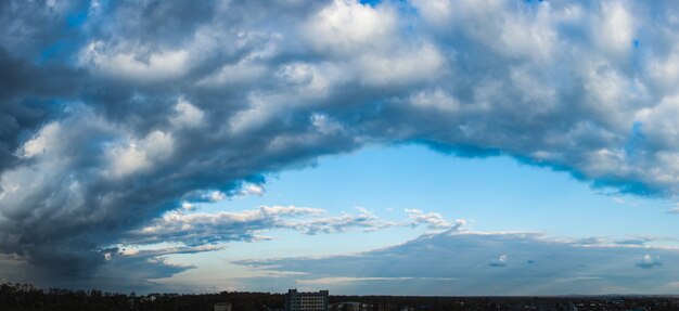 Dramatic dark cloudy sky over the horizon, cloudscape panorama.