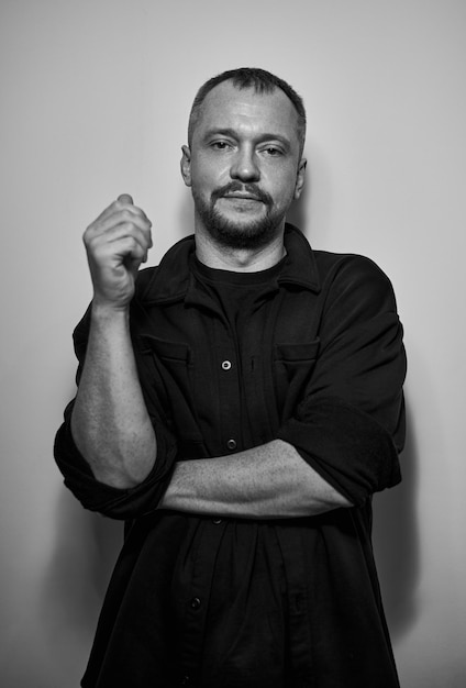 Dramatic portrait of an adult man Studio photography Black and white image