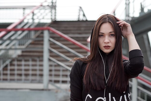 Dramatic portrait of are asian teenager Fine art portrait girl on a city urban stairs background