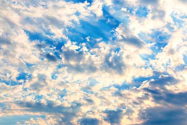 Dramatic sky with feather clouds Sun's rays shine through clouds