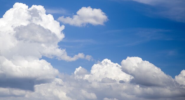 Dramatic sky with sun over the clouds. Blue sky with big white clouds