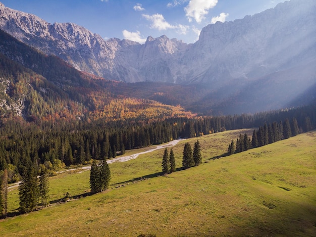 Dramatic sky with sun rays over alpine valley