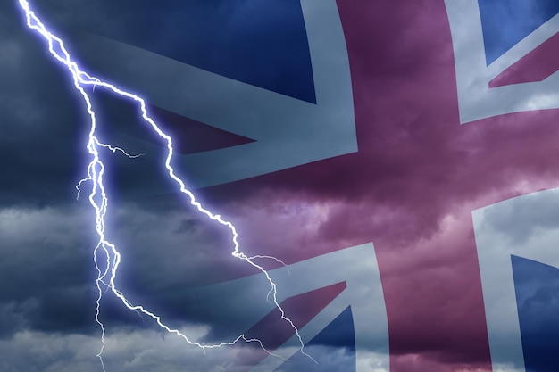 Dramatic stormy clouds with lightning next to uk flag upcoming
crisis and economy problems in britan huge inflation in economy in
uk