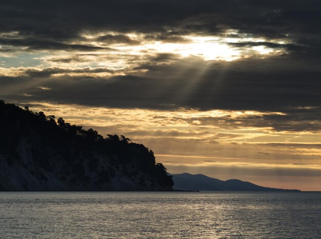 Dramatic sunrays at mountain bay