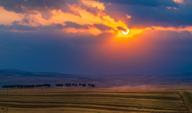 Dramatic sunset over farm fields