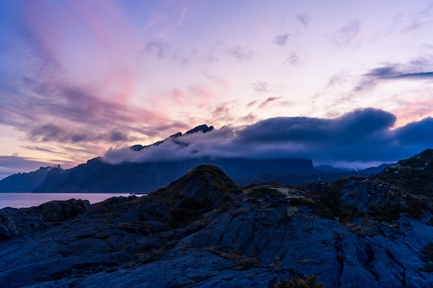 Dramatic sunset landscape with sea and mountains in Lofoten, Norway