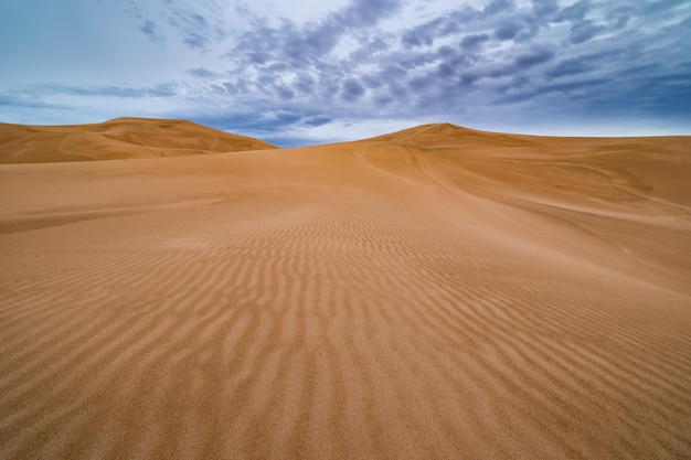 Dramatic sunset over sand dunes in the desert Sahara Desert