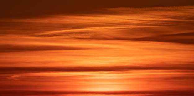 Dramatic sunset, the sun's rays shine through the clouds.