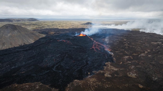 Dramatic view of an erupted volcano red magma boiling in a crater making extreme hot temperature