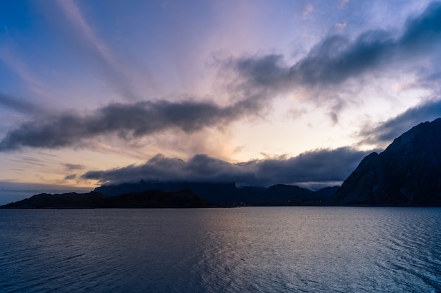 Dramatisch zonsonderganglandschap met overzees en bergen in Lofoten, Noorwegen