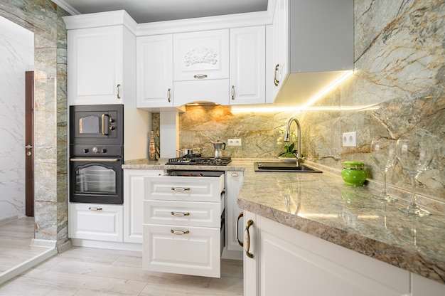 Drawers pulled out at modern classic white kitchen furniture