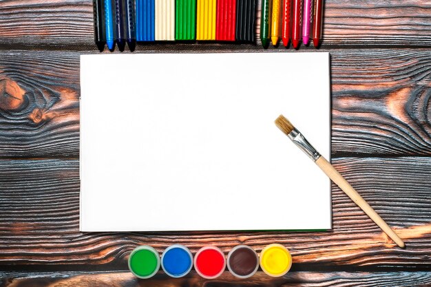 drawing album, brush, wax crayons, finger paints and plasticine