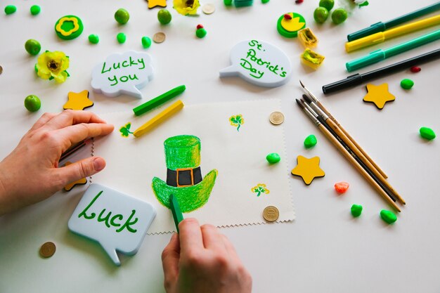 Drawing a green lucky clover st. Patrick. Greenish background. Saint Patrick's Day concept