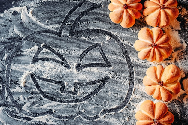 Photo drawing halloween pumpkin on flour  and homemade cookies