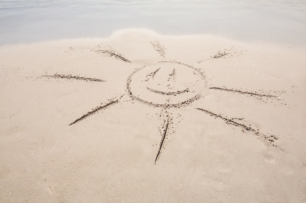 drawing of a sun in the sand