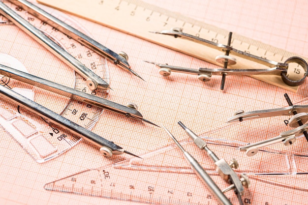 Photo drawing tools, ruler and protractor on graph paper. close up.