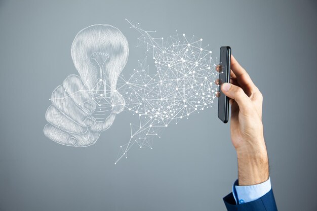 Drawn hand holding a light bulb. a man holding a phone