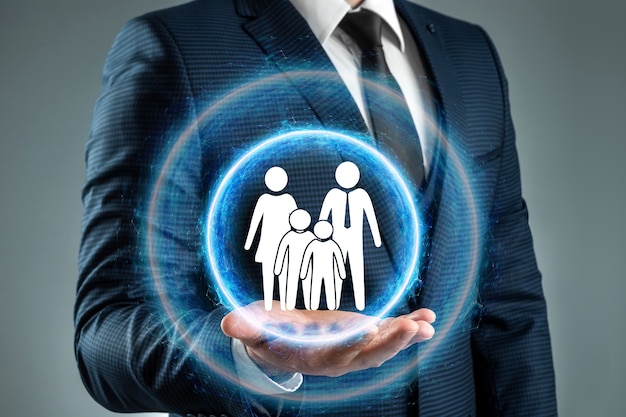 The drawn hands protect the white family figurines. Young family, family protection concept