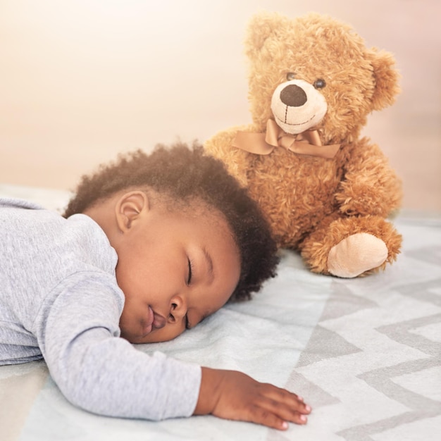 Dream big little one Shot of a little baby boy sleeping on a bed with a teddy bear