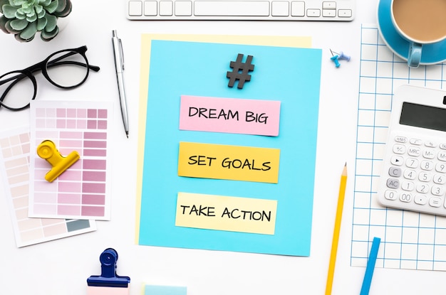 Dream big set goals take action concepts with text on desk table