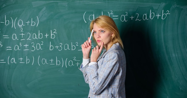 Dreaming of a bright future thoughtful woman Back to school Teachers day teacher on school lesson at blackboard Study and education Modern school Knowledge day woman in classroom