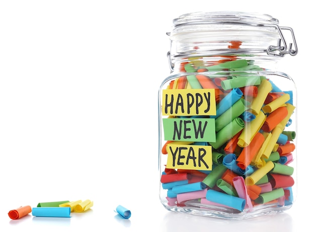 Dreams written on color  rolled paper in glass jar, isolated on white