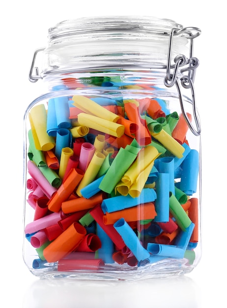 Dreams written on color  rolled paper in glass jar, isolated on white