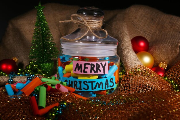 Photo dreams written on color  rolled paper in glass jar, on sackcloth and fabric background