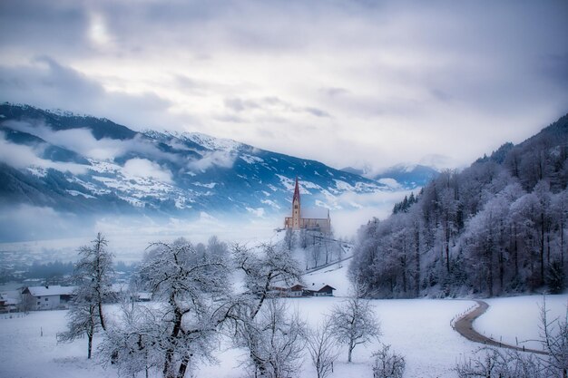 Photo dreamy beautiful winter landscape with a church on a mountain