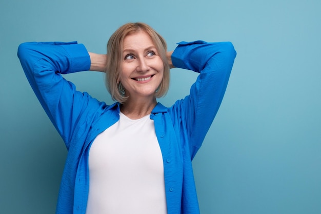 Dreamy blond mature woman with bob haircut on studio background