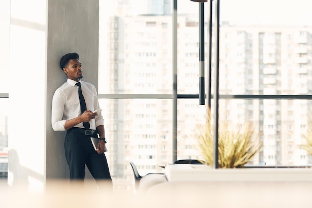 Dreamy handsome businessman in hall