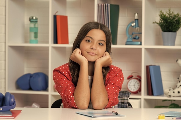 Dreamy kid in classroom ready to study september 1 childhood happiness