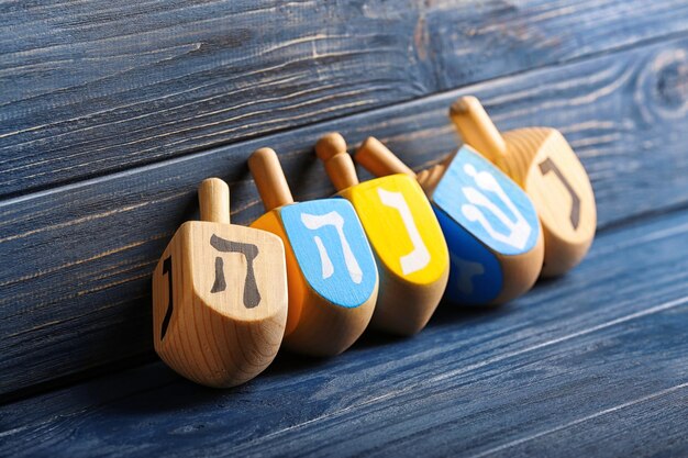 Dreidels for Hanukkah on wooden background