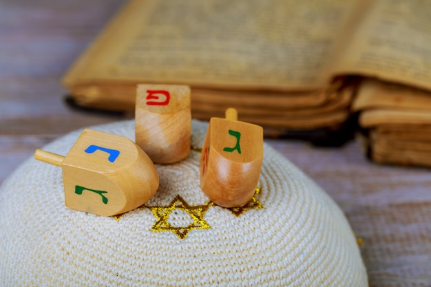 Dreidels for Hanukkah on wooden table