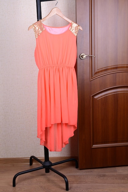 Dress hanging on hanger near door