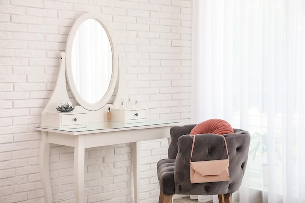 Photo dressing table with mirror in stylish room interior