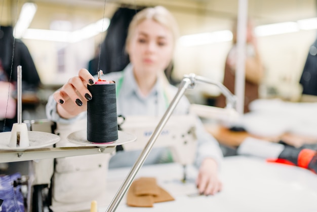 Dressmaker hands sews fabrics on a sewing machine