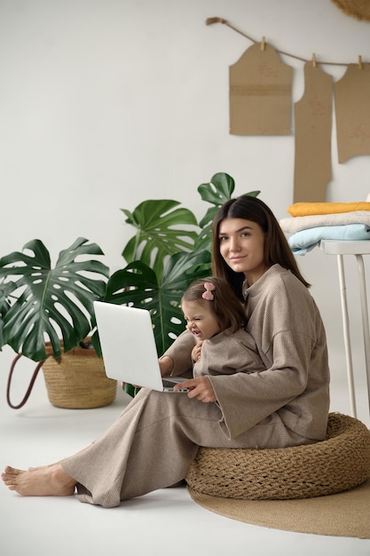 Dressmaker making clothes in her studio with her daughter