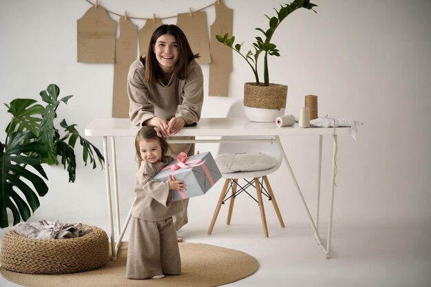 Dressmaker making clothes in her studio with her daughter