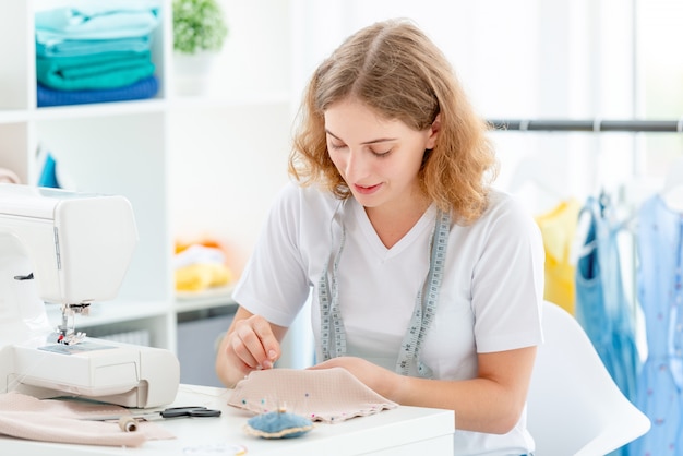 Dressmaker sewing new design by hands