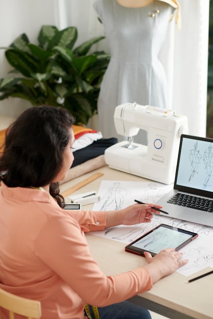 Dressmaker Working on Fashion Sketches