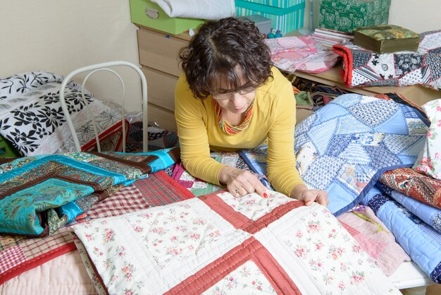 Dressmaker working on her quilt in his workshop