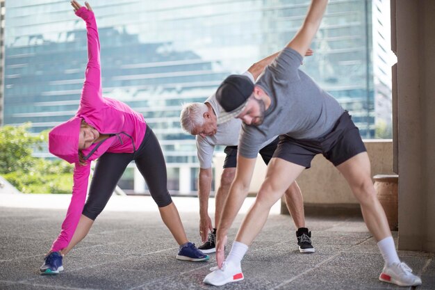 Drie atleten doen gymnastiek in de stad