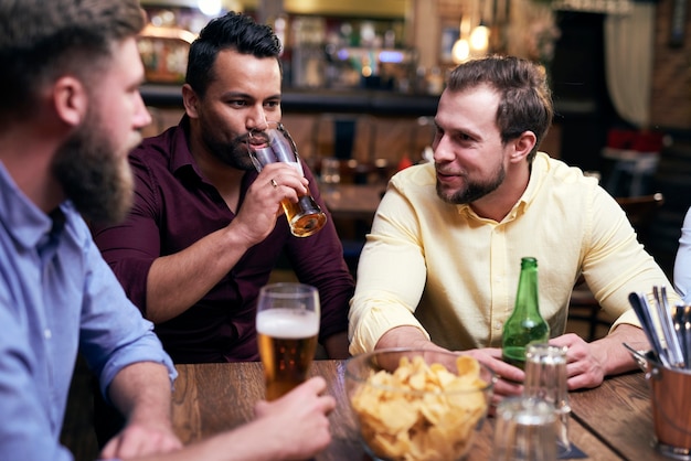 Drie mannen die samen tijd doorbrengen in de kroeg