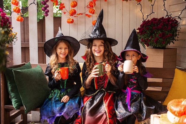 drie meisjeszussen in heksenkostuums veel plezier met het vieren van Halloween