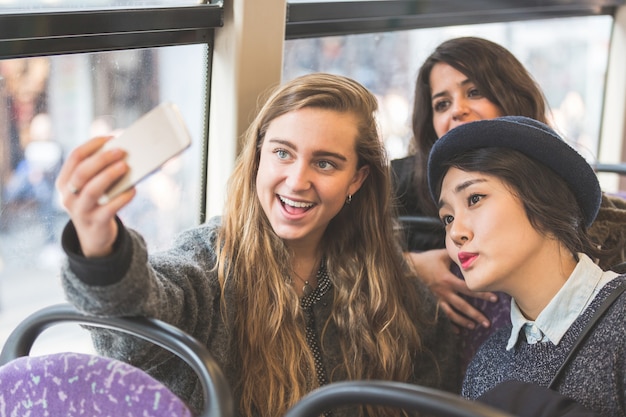 Drie met een selfie in de bus